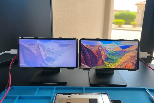 Two mobile phone screens compared side by side on a testing bench in Phoenix, AZ.