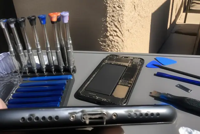 Lint and dust debris inside a smartphone charging port on a workstation in Phoenix, AZ.