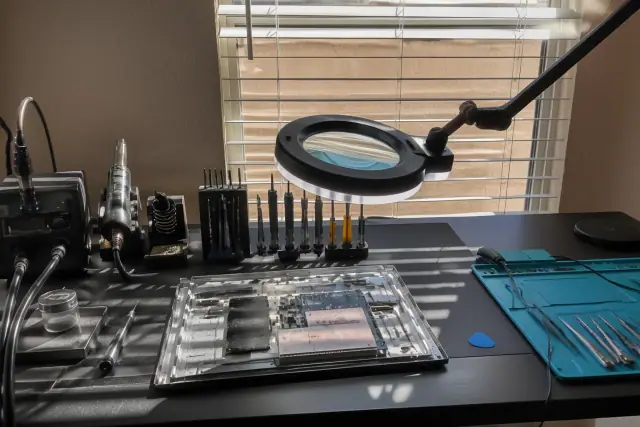 An organized repair workbench with a soldering station and tools in Phoenix, AZ.
