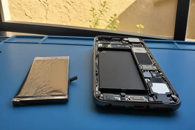 Replacement battery and open smartphone chassis during a repair in Avondale, AZ.