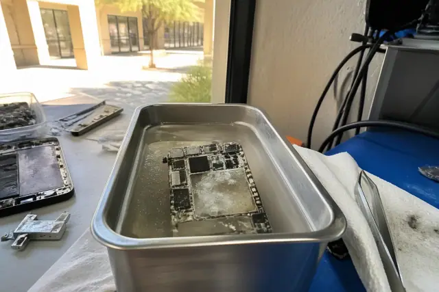 Smartphone circuit board cleaning in an Avondale, AZ workshop to remove water damage and corrosion.