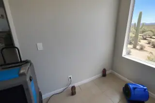 Restored interior wall after water damage repair with drying equipment in a Phoenix, AZ home.