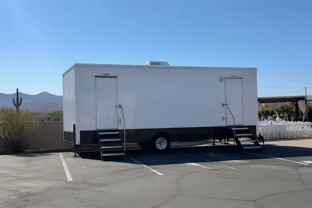 Luxury restroom trailer parked on an asphalt lot at a wedding in Phoenix, AZ.