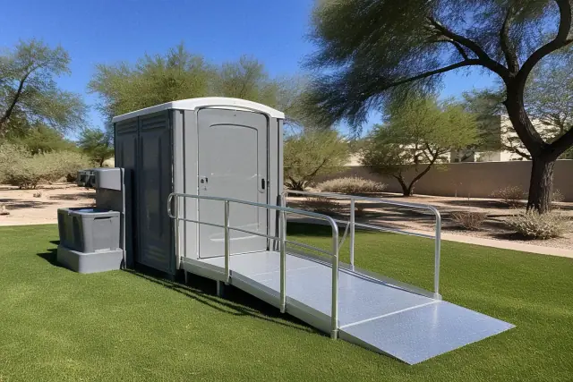 ADA-accessible portable toilet with a ramp and sink on grass in Phoenix, AZ.