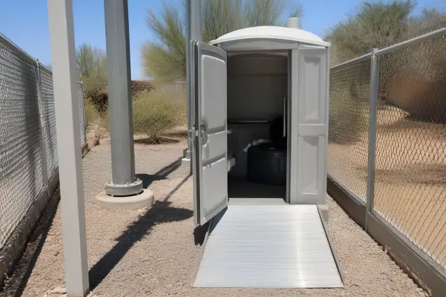ADA-compliant portable toilet with an access ramp at a construction site in Phoenix, AZ.