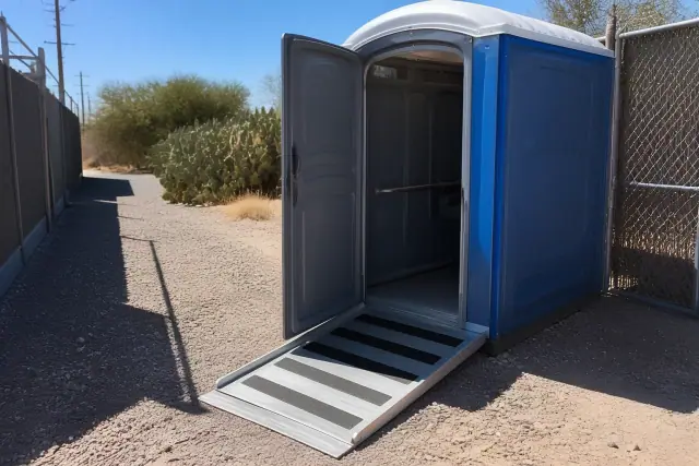 ADA-compliant portable toilet with ramp access on a gravel path in Mesa, AZ.