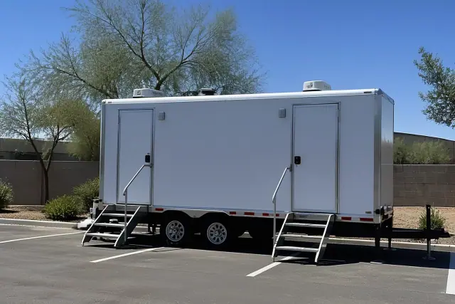 Climate-controlled restroom trailer parked on an asphalt lot in Phoenix, AZ.
