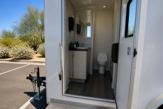 Interior view of a climate-controlled trailer parked on an asphalt lot with desert sagebrush in Phoenix, AZ.