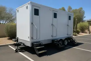 Luxury restroom trailer leveled on a painted asphalt parking lot at a Phoenix, AZ worksite.