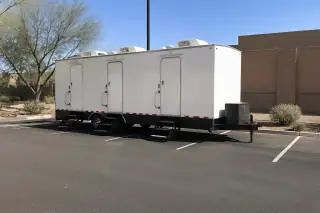 Luxury restroom trailer placed on an asphalt parking lot at a jobsite in Phoenix, AZ.