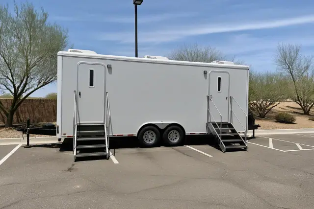 Luxury restroom trailer installed on an asphalt parking lot in Phoenix, AZ.