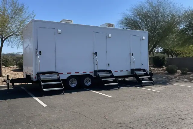 Luxury restroom trailer installed on an asphalt parking lot in Phoenix, AZ.