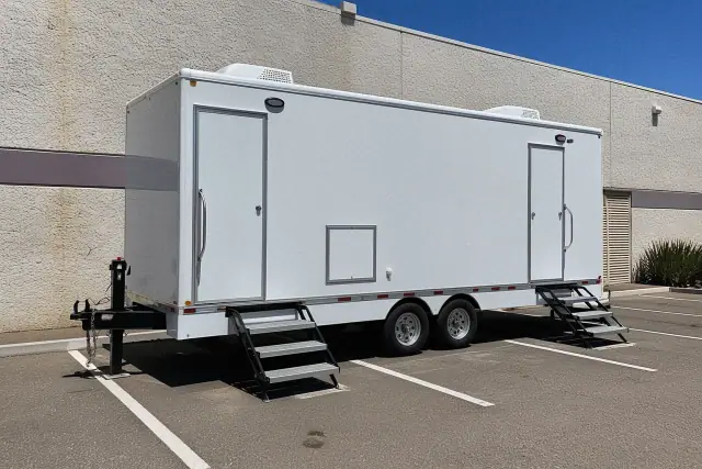 Luxury restroom trailer placed on an asphalt parking lot in Phoenix, AZ.