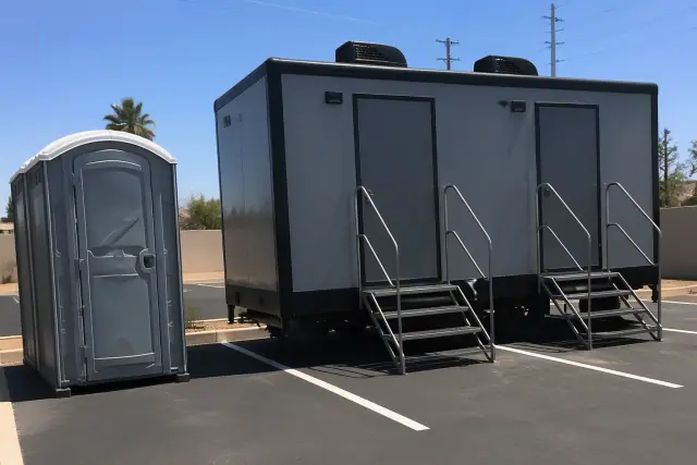 Luxury restroom trailer on a paved parking lot at a job site in Phoenix, AZ.
