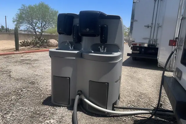 Dual handwashing station unit on a gravel surface at a job site in Phoenix, AZ.