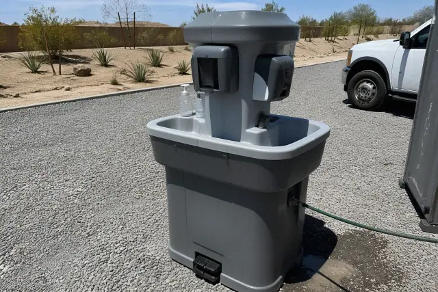 Portable handwashing station on a gravel surface at a jobsite in Chandler, AZ.