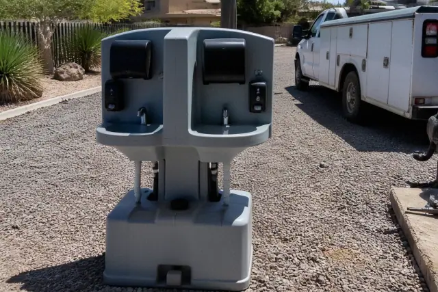 Dual handwashing station on a gravel site in Phoenix, AZ, under bright desert sunlight.