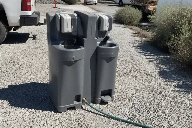 Dual handwashing station on a crushed stone surface at a jobsite in Surprise, AZ.