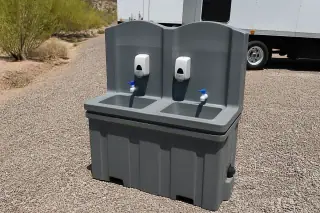 Dual-basin portable handwashing station on a gravel staging area in Phoenix, AZ.
