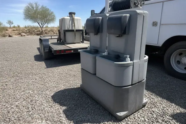 Dual portable handwashing station units on a gravel construction site in Phoenix, AZ.