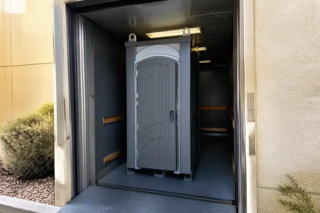 Narrow-profile portable toilet unit for high-rise construction crews in a freight elevator in Gilbert, AZ.