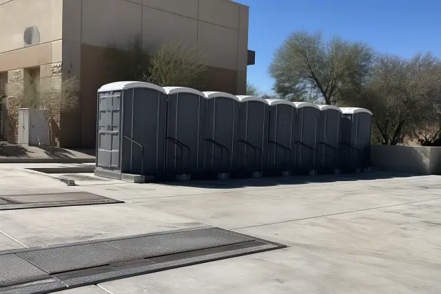 Portable toilet units installed on a concrete loading dock at an industrial site in Phoenix, AZ.