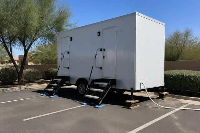 Luxury restroom trailer on a paved lot with desert landscaping in Scottsdale, AZ.