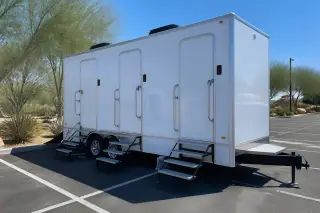 Luxury restroom trailer leveled on a marked asphalt parking stall in Phoenix, AZ.