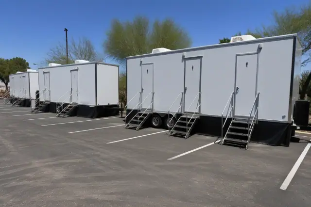 Luxury restroom trailers leveled in a paved parking lot in Phoenix, AZ.