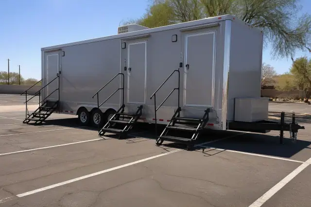 Luxury restroom trailer parked on a leveled asphalt service area in Phoenix, AZ.