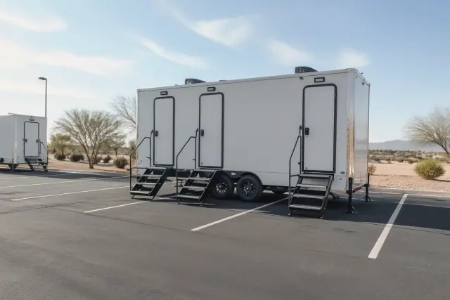 Luxury restroom trailer leveled on a paved parking lot at a jobsite in Phoenix, AZ.