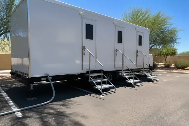 Luxury restroom trailer parked on an asphalt lot in Gilbert, AZ.