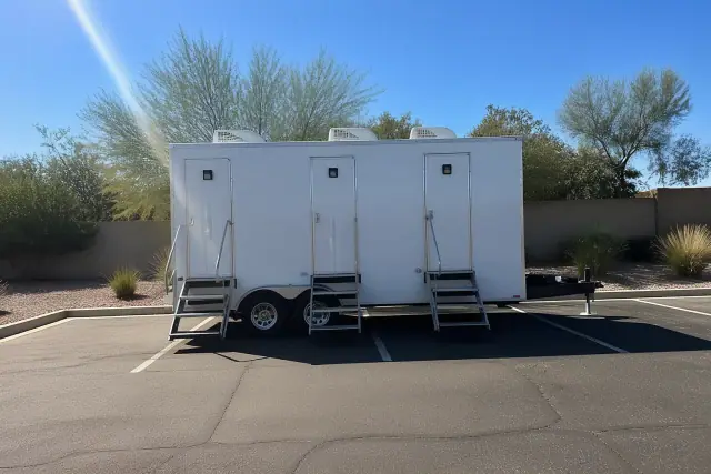 Luxury portable restroom trailer placed on an asphalt parking lot in Phoenix, AZ.