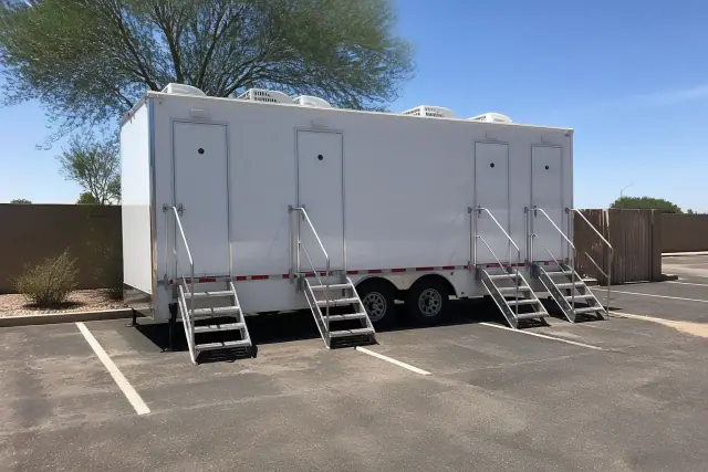 Luxury restroom trailer leveled on an asphalt parking lot in Phoenix, AZ.