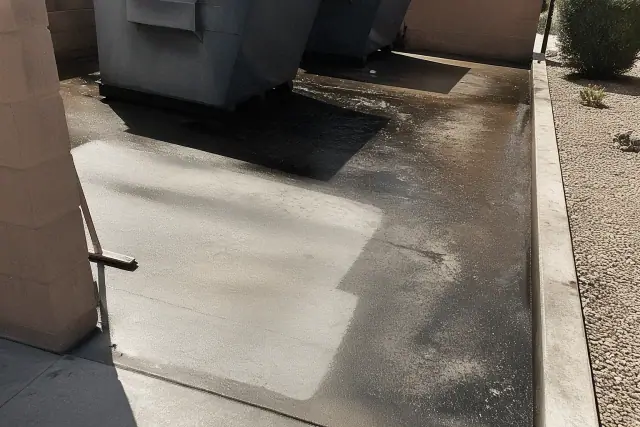 Concrete dumpster pad cleaning process showing grease removal on a sunny day in Tempe, AZ.