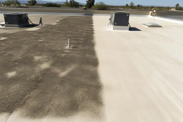 Flat commercial roof in Phoenix, AZ showing a diagonal transition between dirty and clean roofing material.