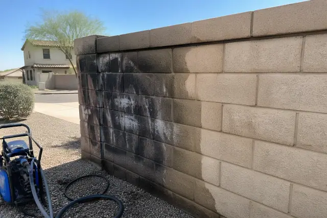 Graffiti removal on a residential brick wall in Goodyear, AZ showing a clean masonry surface.