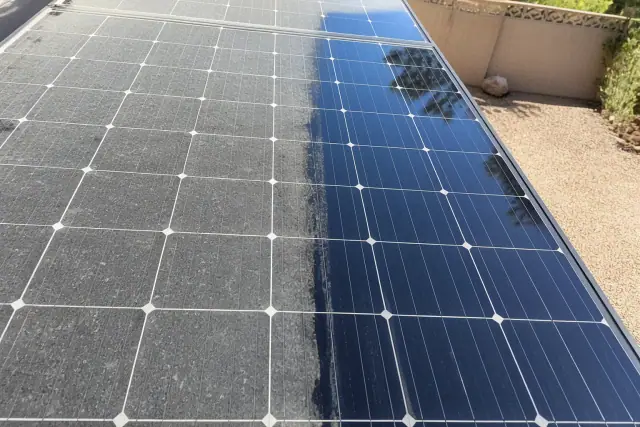Hard water spot removal in progress on a residential solar panel in Phoenix, AZ, showing clean glass against dusty buildup.