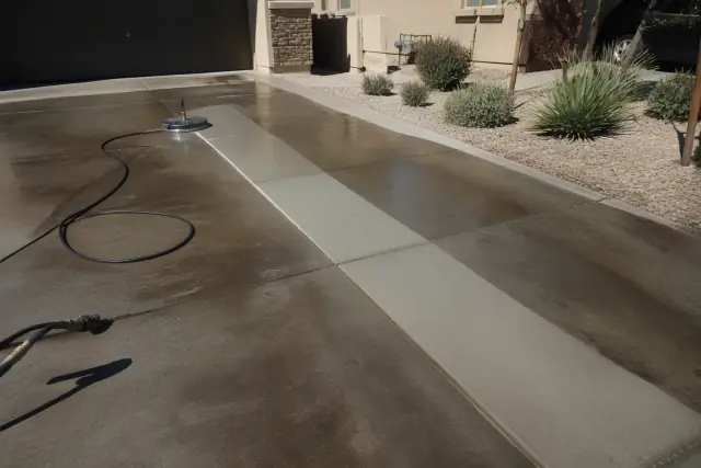 Concrete driveway with clean pressure-washed stripes and desert landscaping in Phoenix, AZ.