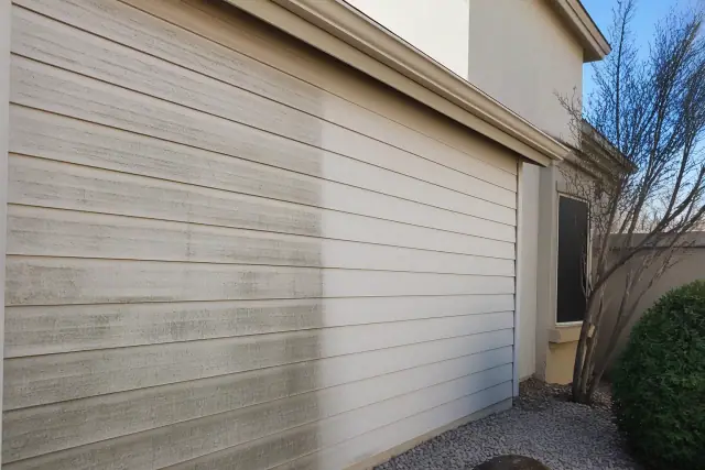 A residential house washing progress photo showing cleaned siding next to mildew-covered panels in Mesa, AZ.