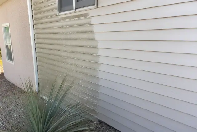 Cleaning mildew from residential vinyl siding on a home in Buckeye, AZ.