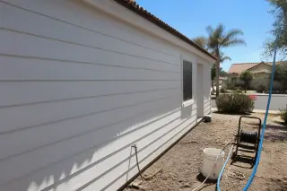 Cleaned residential siding after a soft wash project in Phoenix, AZ, showing sanitized panels and desert landscaping.
