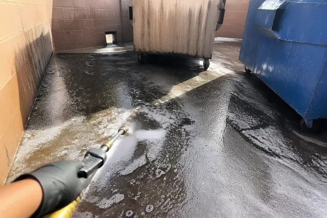 Chemical degreaser lifting oil residue from a parking stall asphalt surface in Phoenix, AZ.