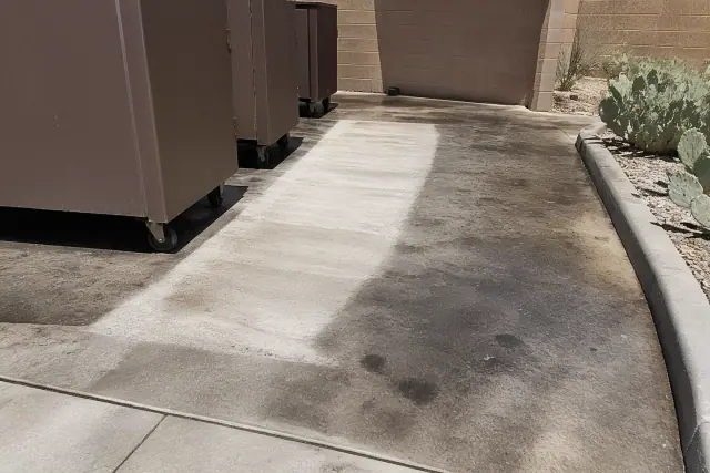 Cleaned concrete floor around trash bins with prickly pear cacti in Phoenix, AZ.