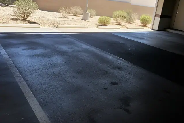 Cleaned asphalt surface in a parking garage showing removed oil stains in Chandler, AZ.