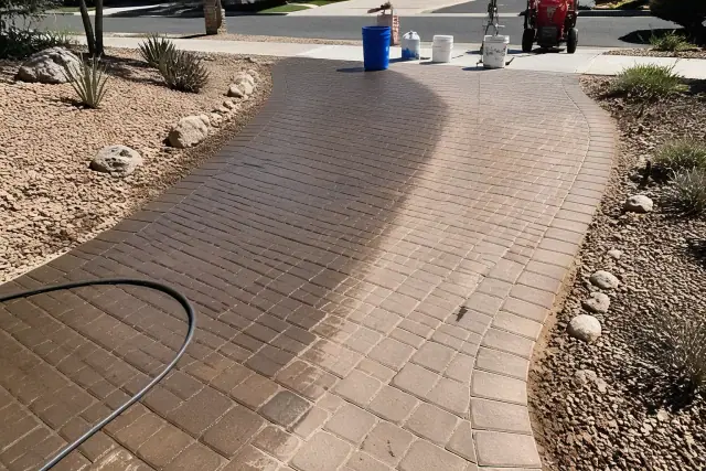 Paver cleaning and sealing in progress on a stone path in Tempe, AZ, showing wet cleaned tiles next to dusty ones.