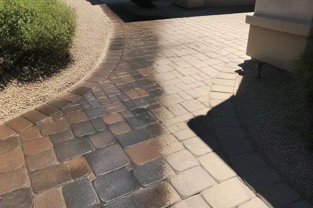 Cleaned and sealed stone paver walkway with high contrast sunlight in a residential yard in Surprise, AZ.