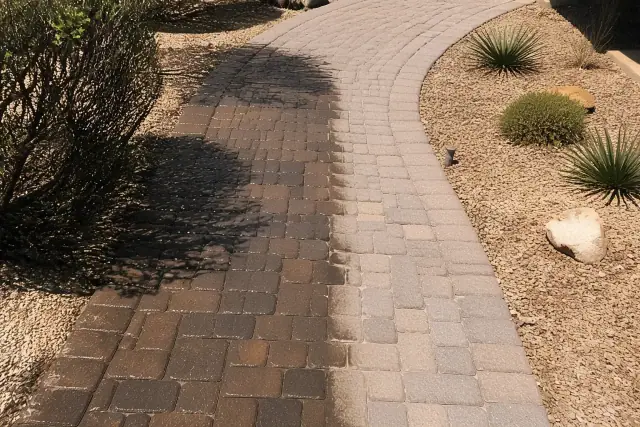 Half-treated paver walkway with stone joints and desert landscaping in Phoenix, AZ.