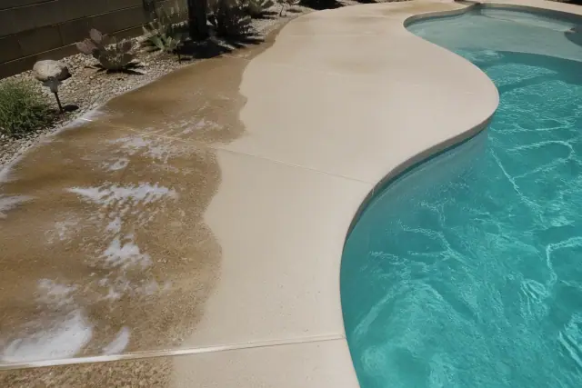 Concrete pool deck being pressure washed in a residential backyard in Surprise, AZ.