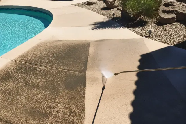 Pressure washing a stained concrete pool deck at a residential property in Goodyear, AZ.